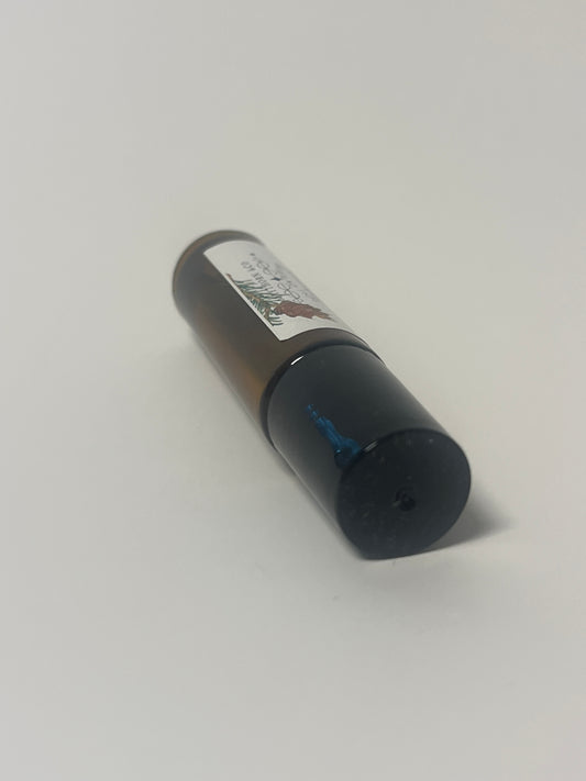 Amberwood Roll-On Perfume by Maythorn & Co featuring a sleek glass bottle with a metal rollerball for easy application.