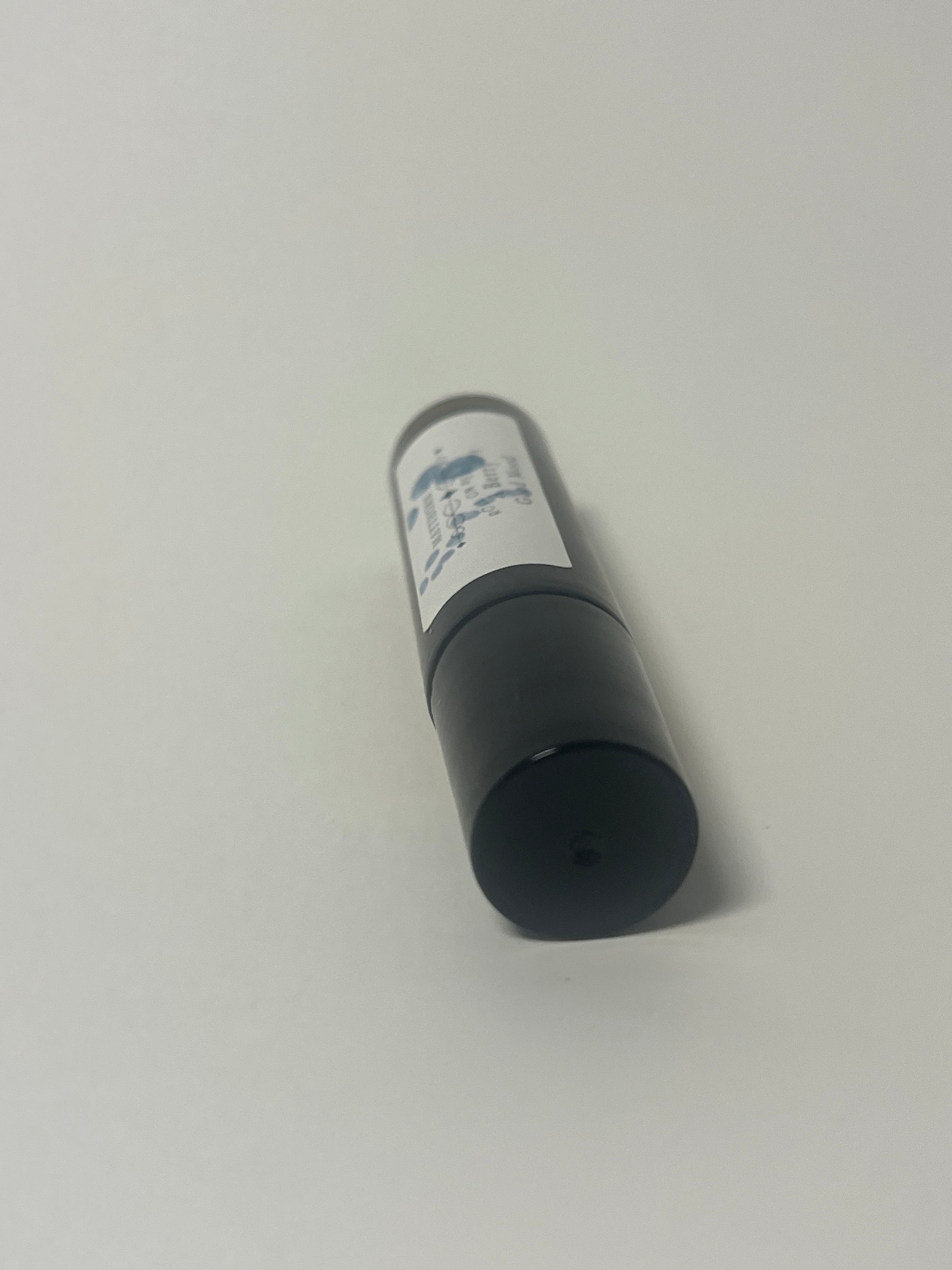 Maythorn & Co A Berry Good Mood roll-on perfume with fresh berry scents in a sleek glass bottle.