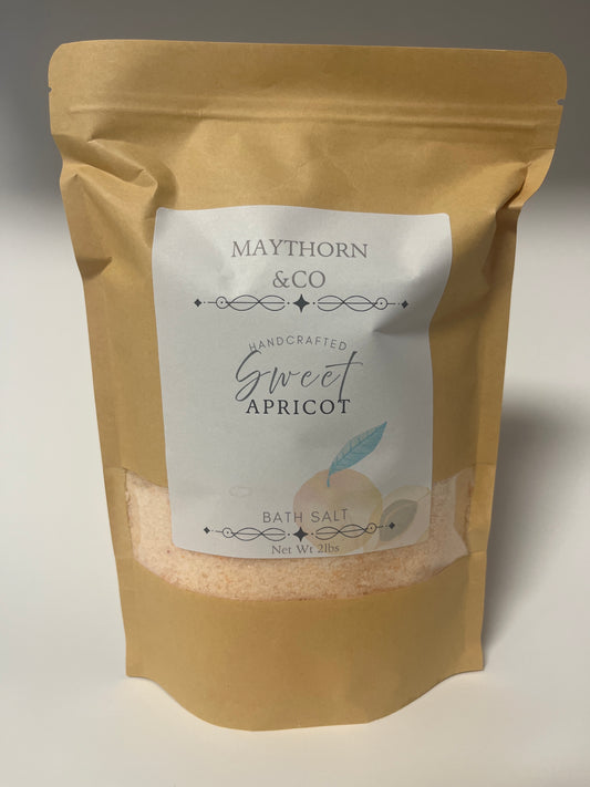 Maythorn & Co Sweet Apricot Bath Salt in a clear jar, showcasing peach-colored salt with apricot pieces for soothing bath relaxation.