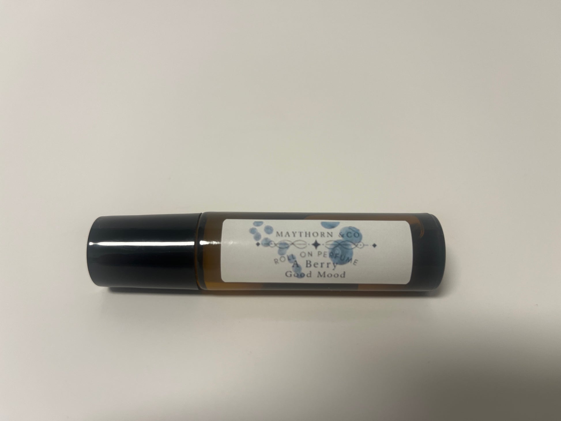 Maythorn & Co Berry Good Mood roll-on perfume bottle with a clear rollerball and colorful berry-themed label.