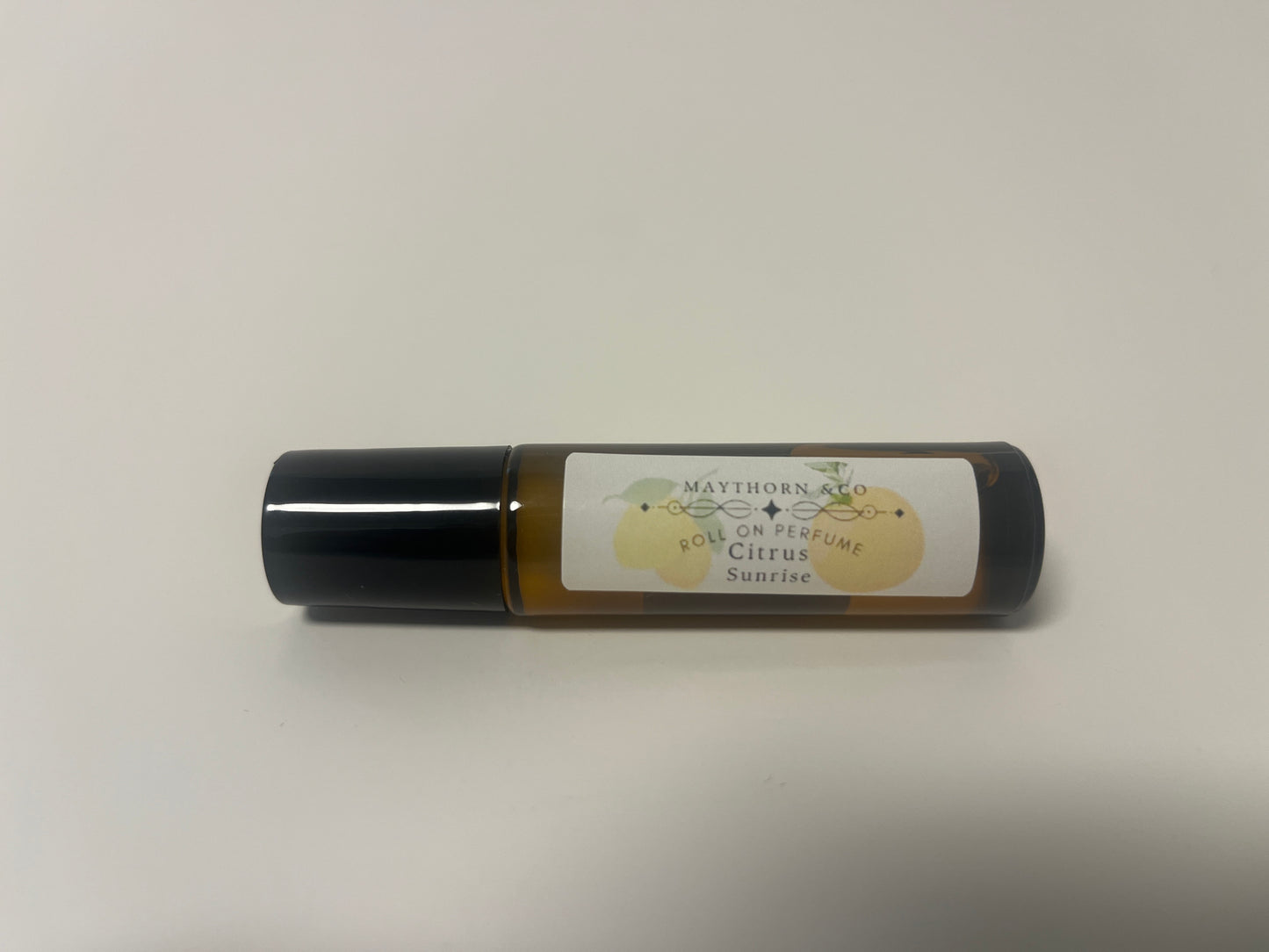Maythorn & Co Citrus Sunrise roll-on perfume bottle with vibrant citrus-themed design.